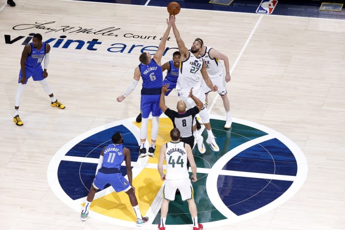 Rudy Gobert (27) and Kristaps Porzingis (6) tip off in a Jazz vs Mavericks matchup